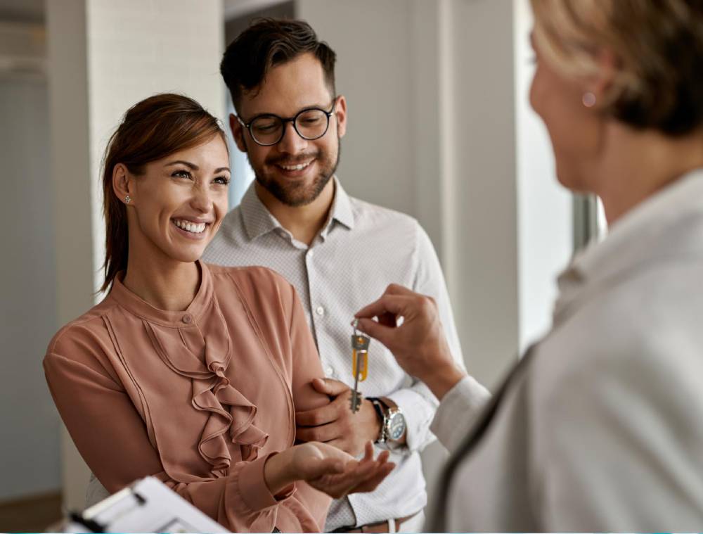 Agent giving key to the home owner